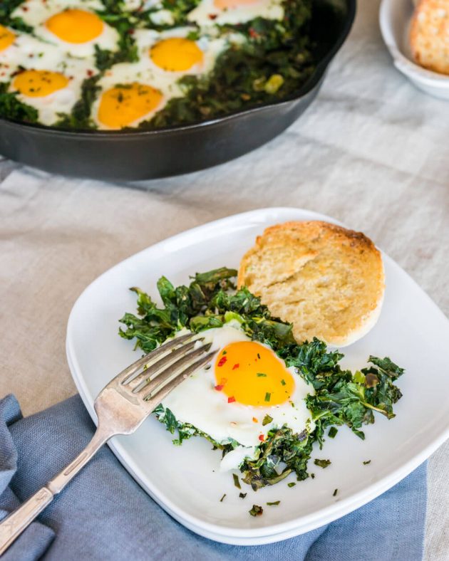 Baked eggs with crispy kale, a quick and easy recipe for breakfast or brunch. Fragrant herbs add a punch of flavor unexpected in a healthy breakfast recipe.
