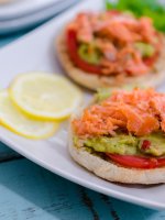 Avocado toast with smoked salmon on crisp toasted English muffins topped with tomato, Sabra's new Veggie Fusions guacamole + veggies is the perfect healthy lunch for busy days.