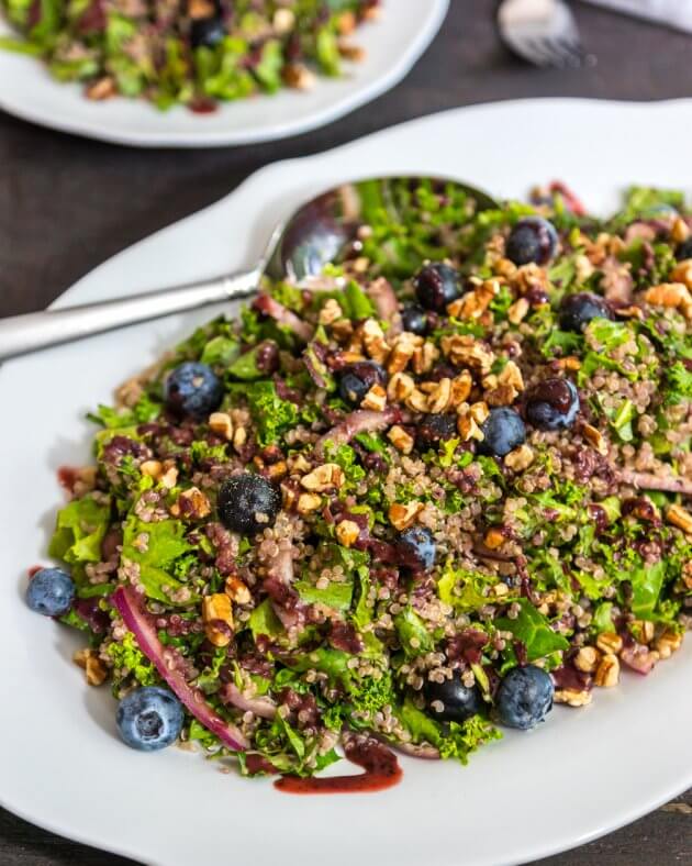 Quinoa Salad with kale, a super-food salad dressed for a party. Topped with crunchy pecans and tangy blueberry dressing. You'll love this make-ahead lunch.